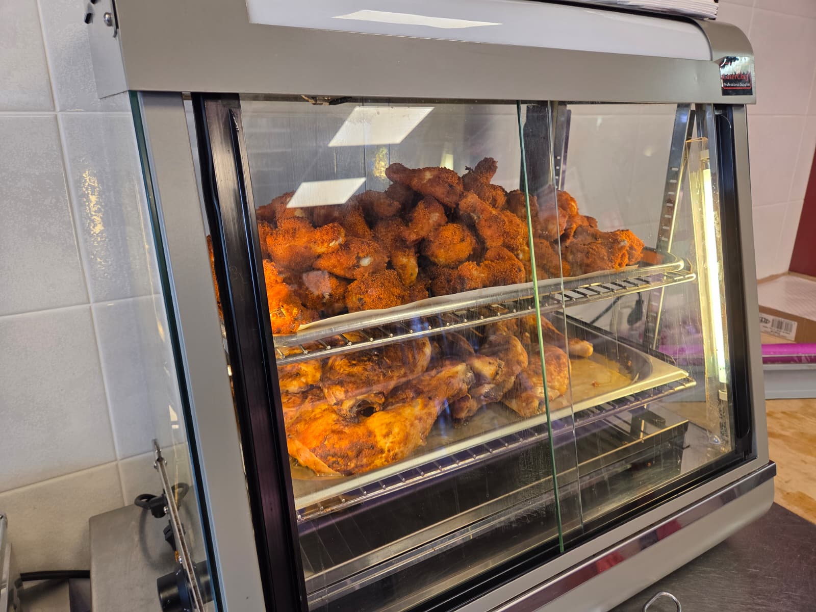 Vers gebakken halal kip in de warme vitrine